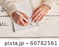Beautiful female hands write in notebook. 60782561
