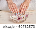Spa for hands. Delicate flowers in a glass bowl. 60782573