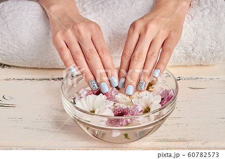 Spa for hands. Delicate flowers in a glass bowl. Spa for hands. Delicate flowers in a glass bowl. 60782573