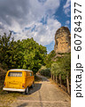 Yellow car on cobblestone road in Greece 60784377