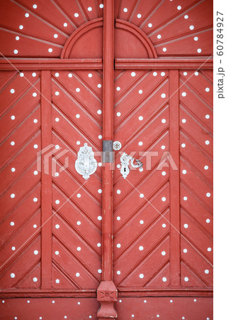Beautiful old red wooden door in castle 60784927