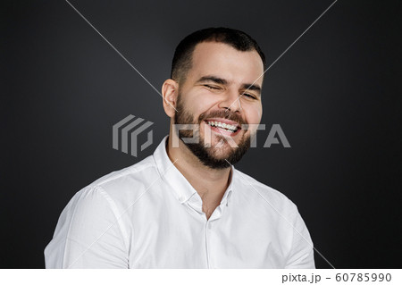 Close-up portrait of happy handsome bearded man laughing 60785990