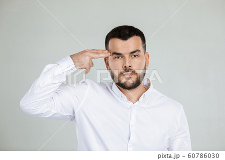 bearded man shooting in temple with hand bearded man shooting in temple with hand 60786030
