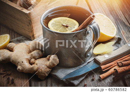 Ginger tea cup with lemon and cinnamon. 60786582