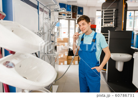 Plumber buying shower in plumbering store 60786731
