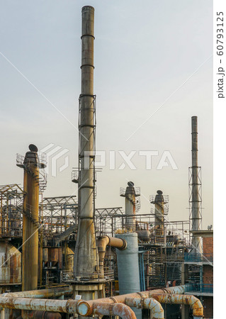 ndustrial plant with old rusty pipes and cooling tower ndustrial plant with old rusty pipes and cooling tower 60793125