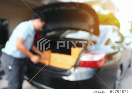 businessman packing box in car preparing express delivery 60794872