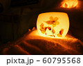 Candle light in ice and snow on Christmas day 60795568