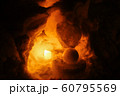 Candle light in ice and snow on Christmas day 60795569