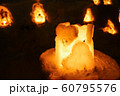 Candle light in ice and snow on Christmas day 60795576