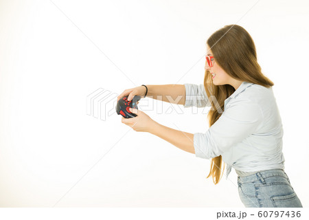Profile view of woman playing video games 60797436