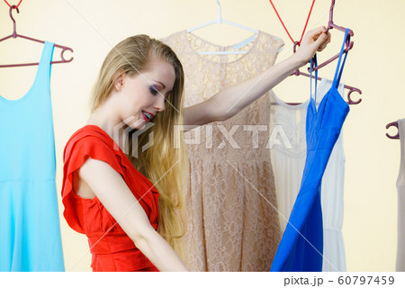 Woman choosing clothes in shop Woman choosing clothes in shop 60797459