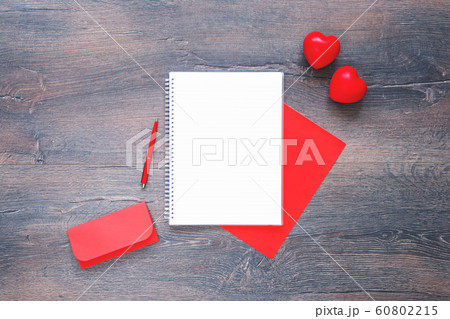 Two red hearts with envelope and notepad on wooden Two red hearts with envelope and notepad on wooden 60802215