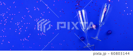 Champagne glasses with confetti on classic blue 60803144