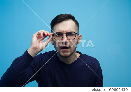 Poorly seeing young man with glasses 60803430