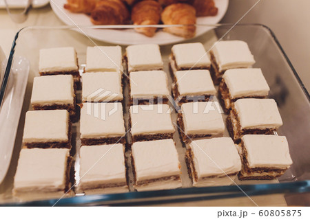 Many banana muffins. stack of banana muffins on a black plate closeup. Banana Cupcake Delicious Homemade on wood tray Freshly baked, sugary muffins. delicious mini cake flavor muffins for breakfast. 60805875