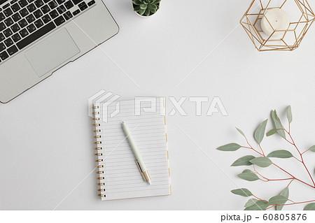 Notebook with pen, candle, domestic plant, branch with green leaves and laptop 60805876