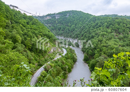 A gorge in the mountains with a suspension bridge A gorge in the mountains with a suspension bridge 60807604