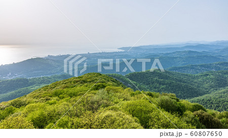 Layers of mountains and the sea in a haze in the light of the sunshine Layers of mountains and the sea in a haze in the light of the sunshine 60807650