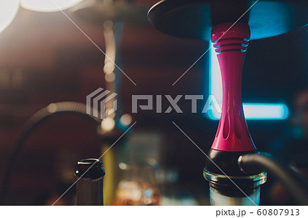 A whole hookah is on the table in the restaurant, smoke, golden mine, dark wood, club, hookah, rest in the lounge bar. 60807913