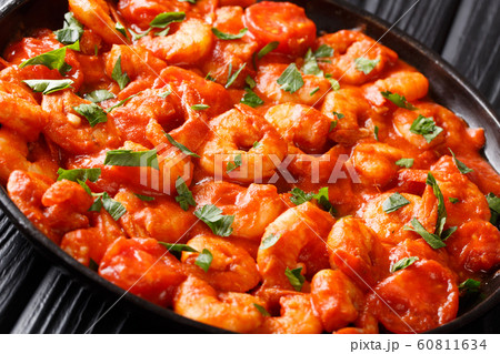 Fresh fried shrimp stewed in tomato sauce close-up Fresh fried shrimp stewed in tomato sauce close-up 60811634