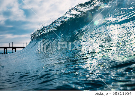 Blue crystal wave in ocean. Breaking wave and sun light 60811954