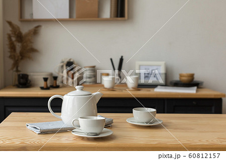White tea set for tea drinking on served table in kitchen 60812157