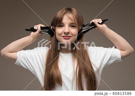 girl makeup artist with makeup brushes spread her arms to the sides on a dark background girl makeup artist with makeup brushes spread her arms to the sides on a dark background 60813586