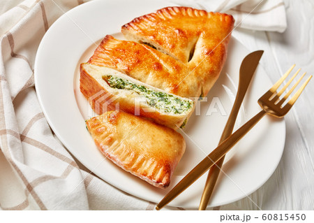 freshly baked calzone with Spinach and Cheese freshly baked calzone with Spinach and Cheese 60815450