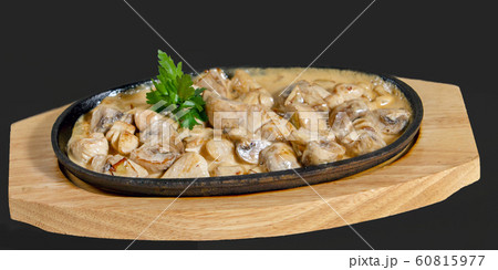 stewed mushrooms (champignons) in sour cream 60815977