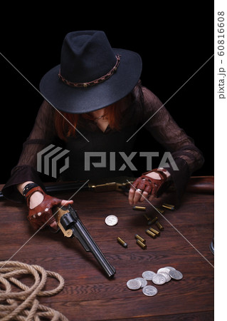 wild west girl shooting from revolver gun  60816608
