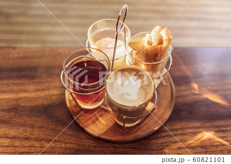 Vintage hot coffee set with soft boiled eggs and toasted sticks on wooden table in morning sunlight Vintage hot coffee set with soft boiled eggs and toasted sticks on wooden table in morning sunlight 60821101