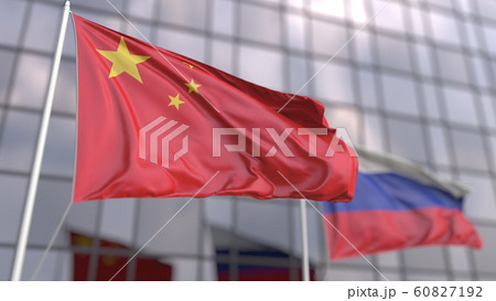 Waving flags of China and Russia in front of a modern skyscraper facade. 3D rendering 60827192