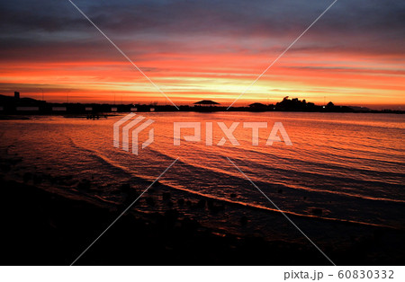 Dramatic twilight sky with silhouette of island Dramatic twilight sky with silhouette of island 60830332