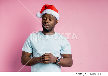 African american man wearing Santa hat 60831186
