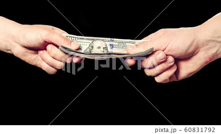 Close up of a businessman's hands holding money 60831792