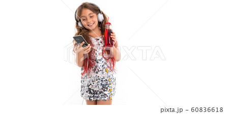 Little pretty caucasian girl listen to music with big earphones and smiles, pa isolated on white Little pretty caucasian girl listen to music with big earphones and smiles, pa isolated on white 60836618