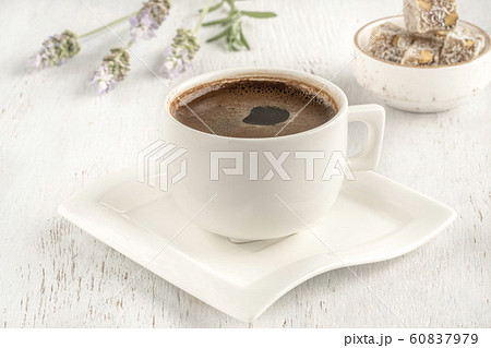 Cup of coffee served with Turkish delight on Cup of coffee served with Turkish delight on 60837979
