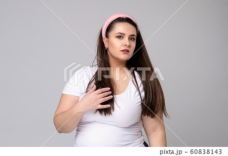 Plus size woman with hair rim in her hair. 60838143