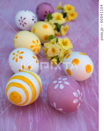 Easter eggs and primrose bouquets on the violet Easter eggs and primrose bouquets on the violet 60841104