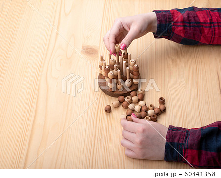 Girl plays tic tac toe. Bright manicure on nails. 60841358