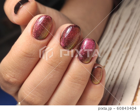 Gray striped nail design on female hand close up. 60843404