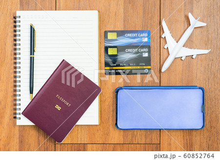 Airplane by passport and cellphone with notepad 60852764
