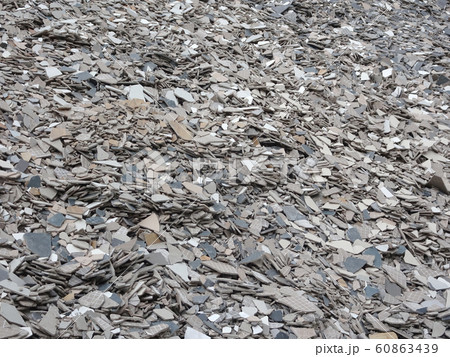 Broken homogeneous and ceramic floor tiles. Broken tiles are collected in one area before being processed and reused. 60863439