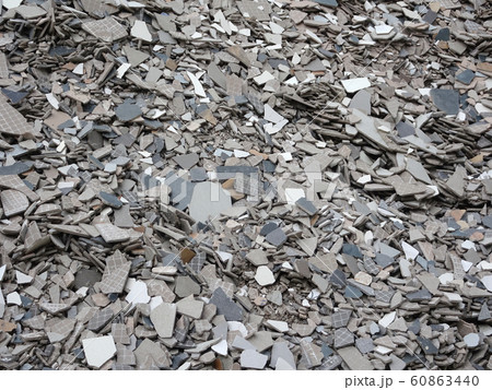 Broken homogeneous and ceramic floor tiles. Broken tiles are collected in one area before being processed and reused. Broken homogeneous and ceramic floor tiles. Broken tiles are collected in one area before being processed and reused. 60863440
