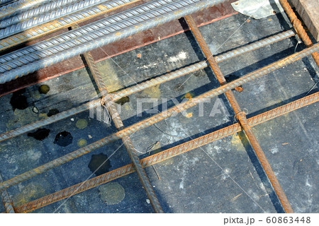 Steel reinforcement bar used to reinforced concrete at the construction site. It was tied together using tiny wires. Fabricate in-situ by construction workers. Steel reinforcement bar used to reinforced concrete at the construction site. It was tied together using tiny wires. Fabricate in-situ by construction workers. 60863448