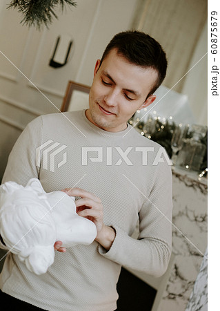 Young man with sculpture bust in an art workshop Young man with sculpture bust in an art workshop 60875679