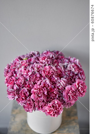 Violet mono bouquet of carnation. European floral shop. the work of the florist at a flower shop. Delivery fresh cut flower. 60876674