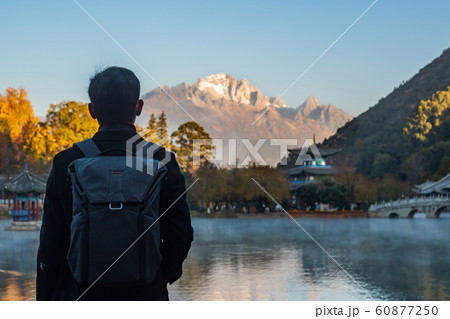 Young man traveler traveling at Black Dragon Pool 60877250