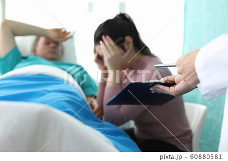 Disappointed visitor in hospital room 60880381